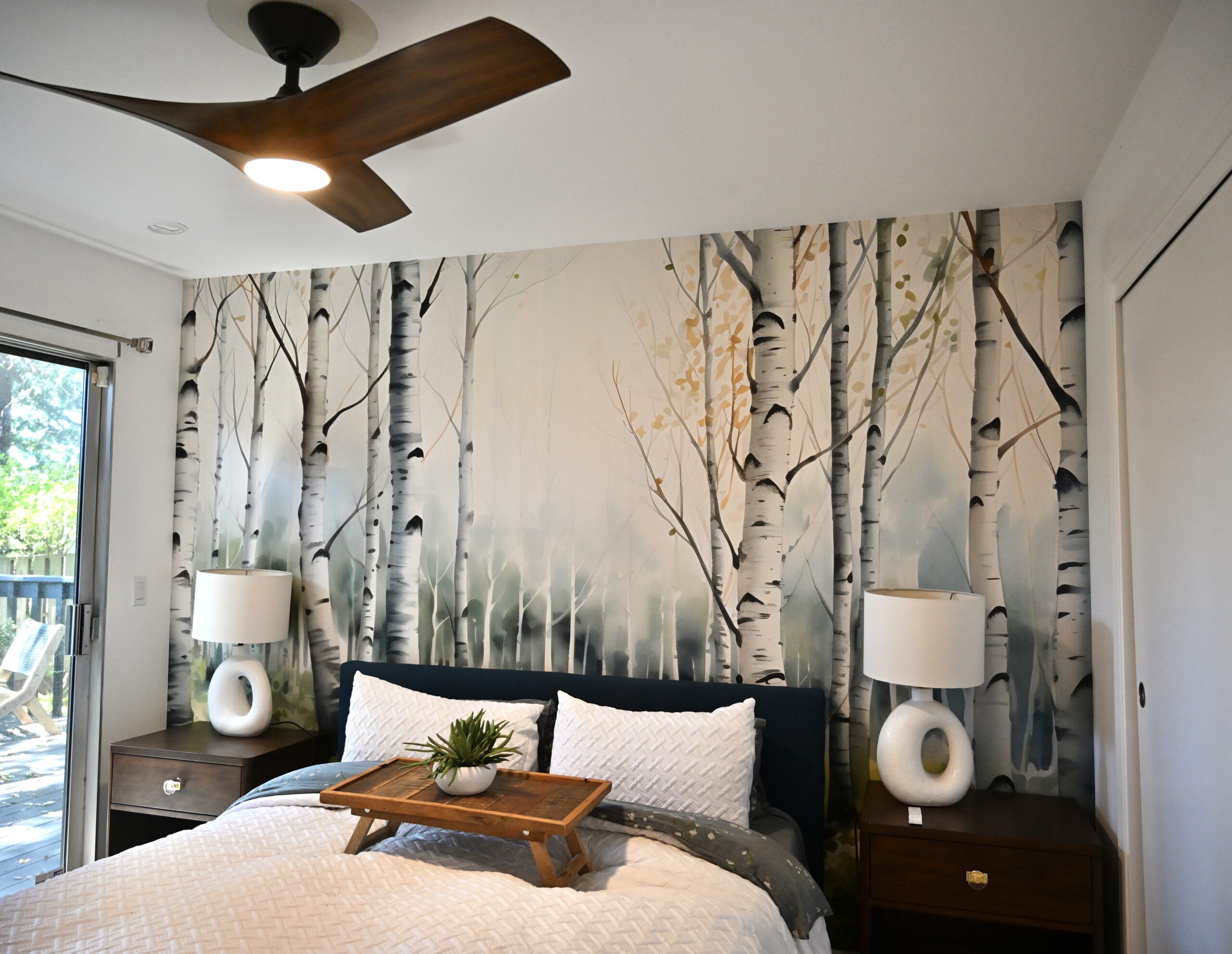 Professional wallpaper installer from Parfait Wallpaper Service carefully applying decorative wallpaper to residential wall