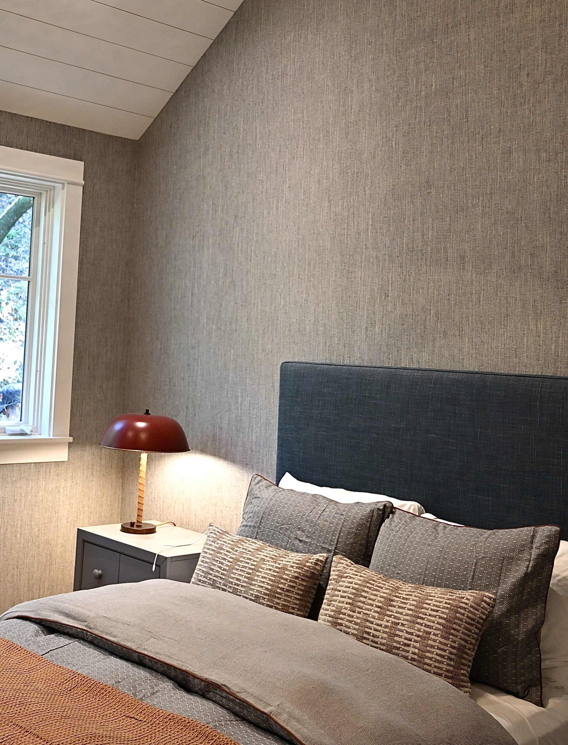Professional wallpaper installer from Parfait Wallpaper Service applying decorative wallpaper to residential wall