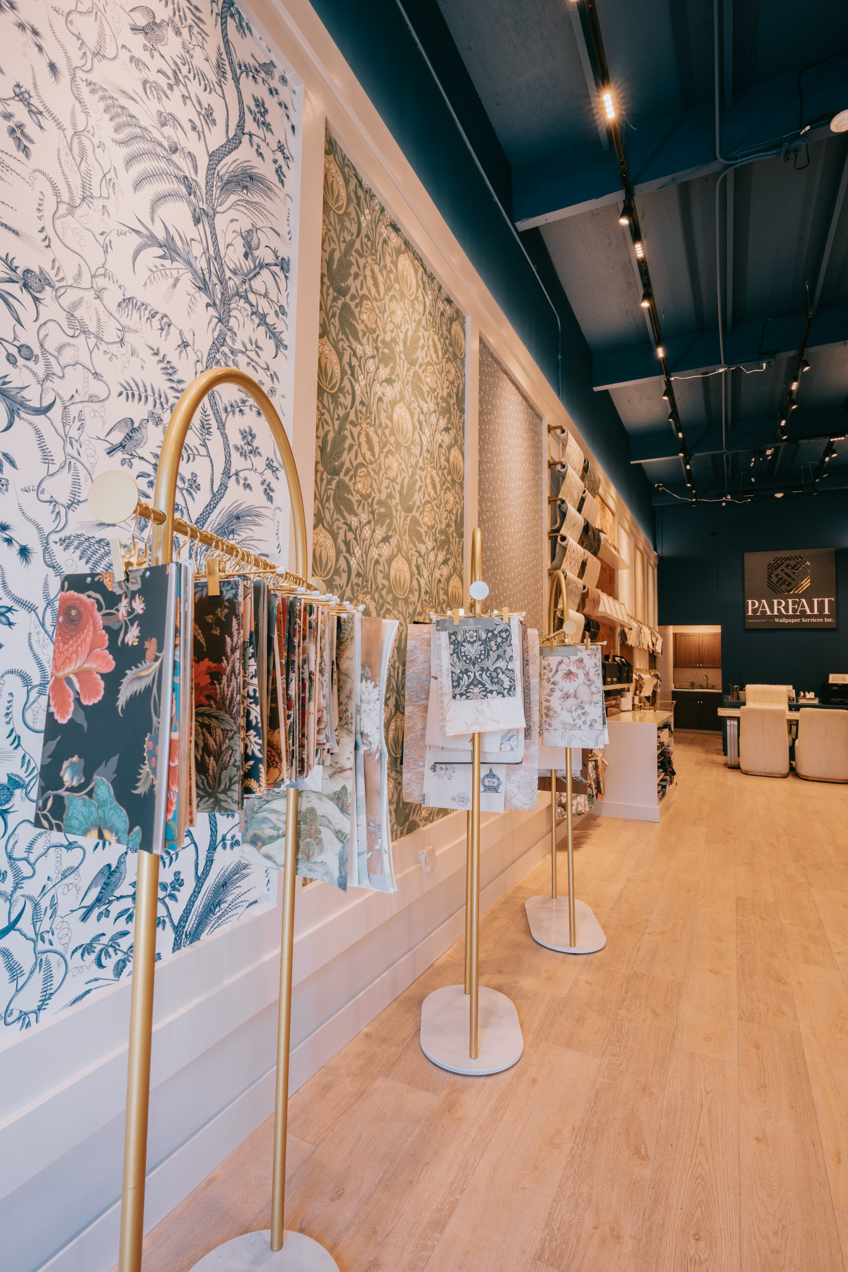 Professional wallpaper installer from Parfait Wallpaper Service carefully measuring and hanging decorative wallpaper on residential wall