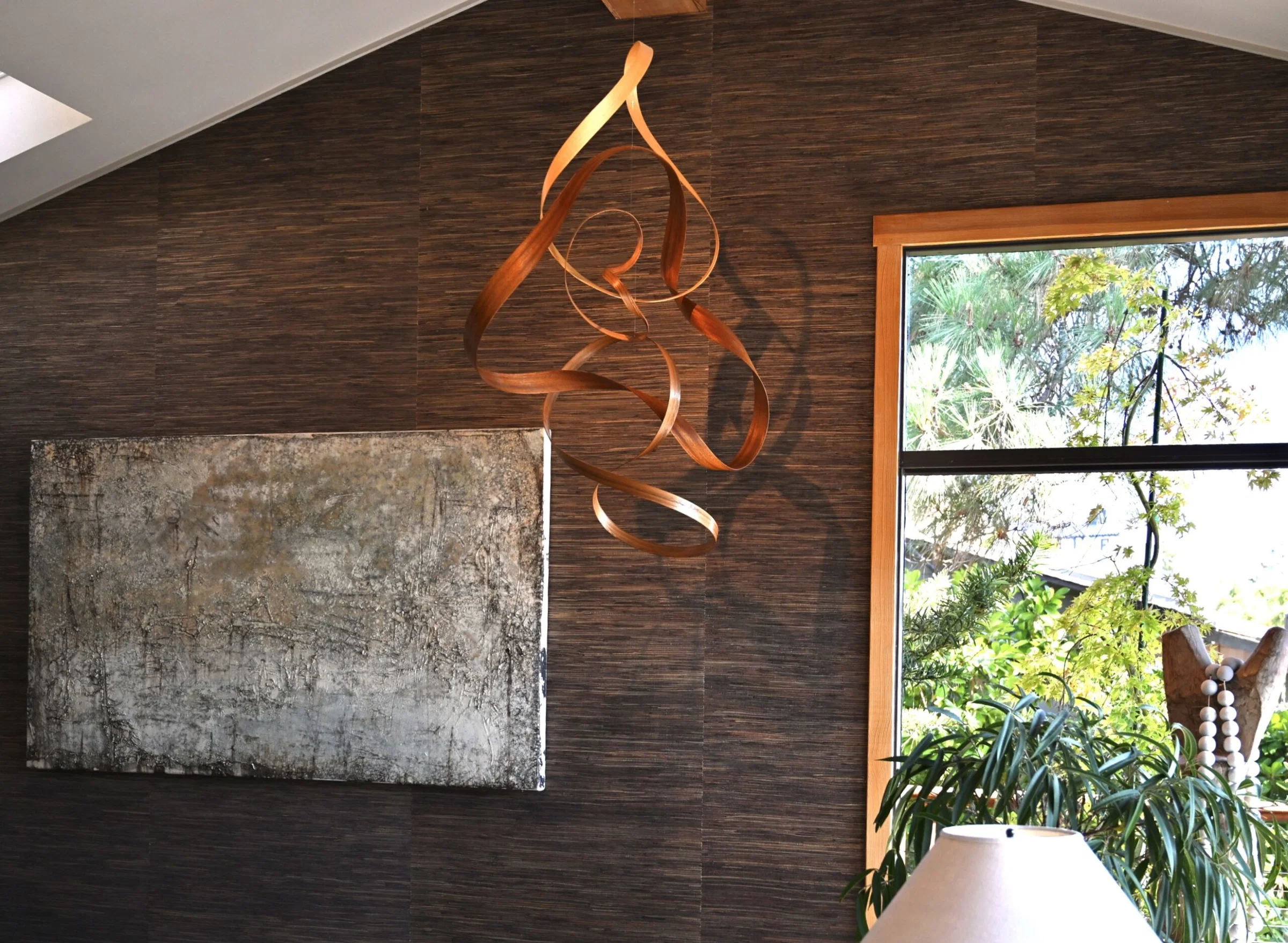 Professional wallpaper installation service showing skilled technician applying decorative wallpaper to residential wall