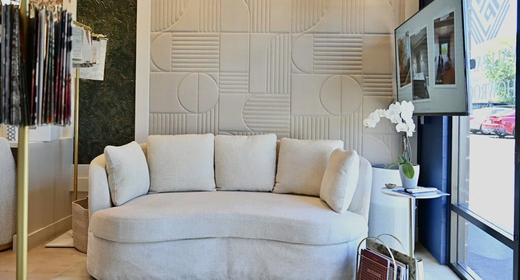 Professional wallpaper installer applying decorative wallpaper to residential wall with precision tools