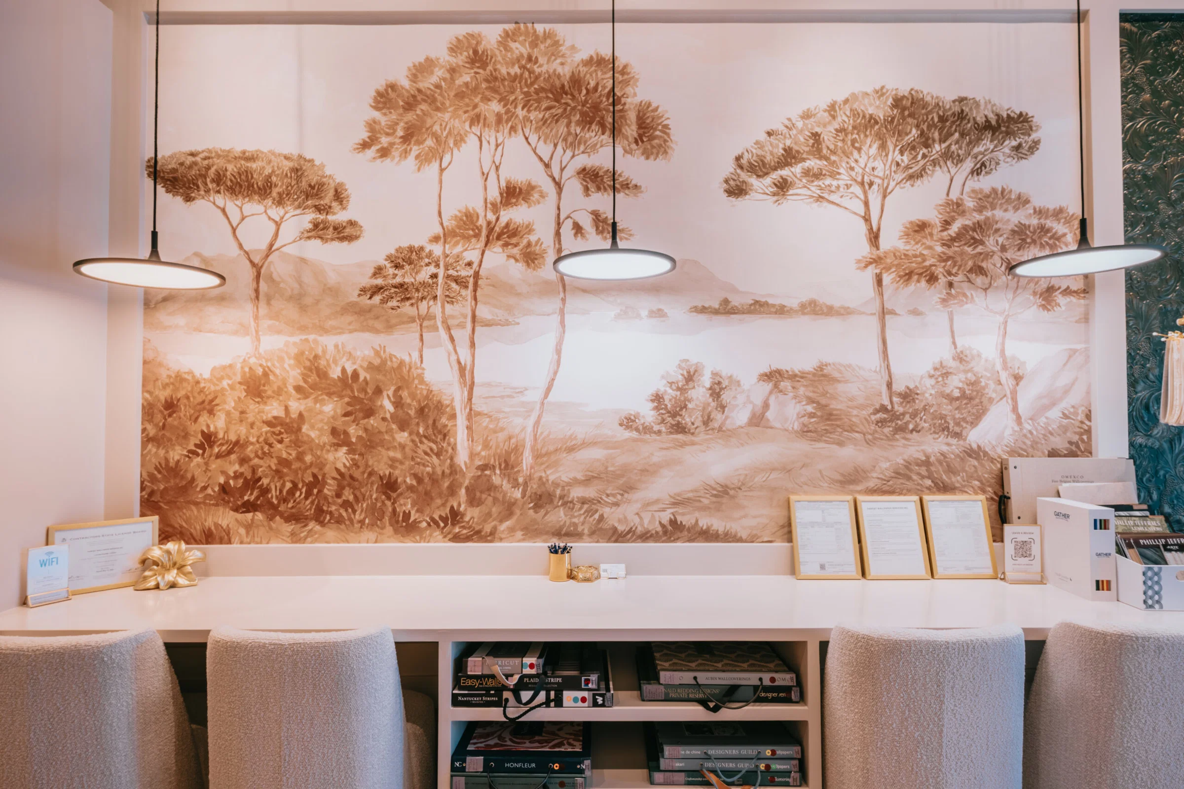 Professional wallpaper installer applying decorative wallpaper to residential wall with precision tools